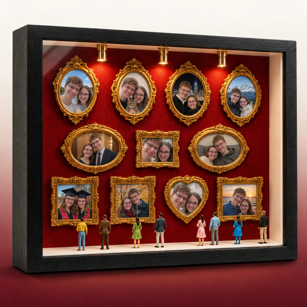Museum of Us shadow box with 11 gold frames of a couple's photos, lit by three warm spotlights on red felt