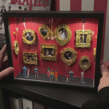 Finished Museum of Us personalized mini museum with gold photo frames, miniature visitors and warm lights